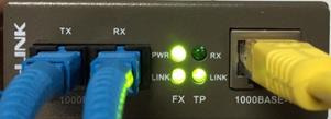 What can I do if the TP-Link FX light is not on after the fiber ports are connected?